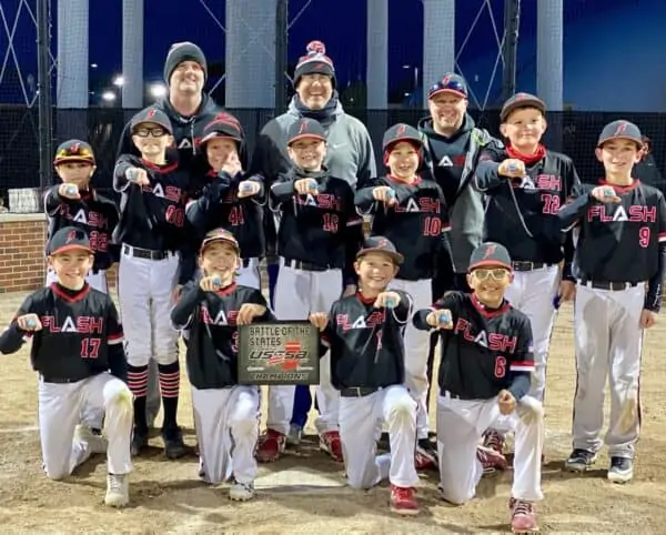 11 U boys Flash baseball team with coaches kneeling wearing rings and holding a championship plate for Battle of the States USSSA