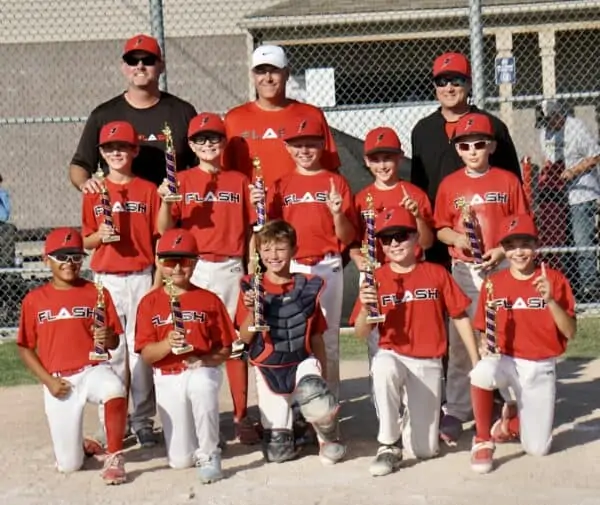 11U boys Flash baseball team with coaches holding championship trophies