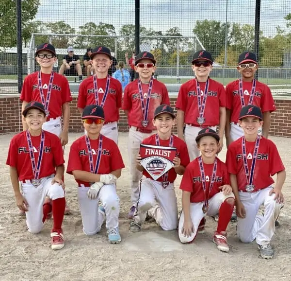 11U Flash baseball team kneeling holding a Gameday finalist home plate