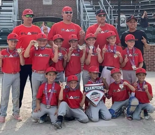 9U Flash baseball team with Gameday homeplace wearing championship medals
