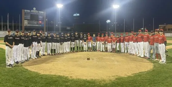 Flash red and black baseball teams standing around the trophy cup on a baseball field