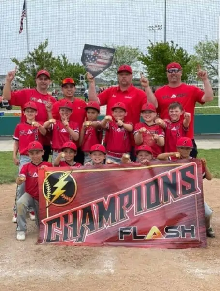 9U boys Flash baseball team holding a champions banner for the Ron Kittle Classic tournament